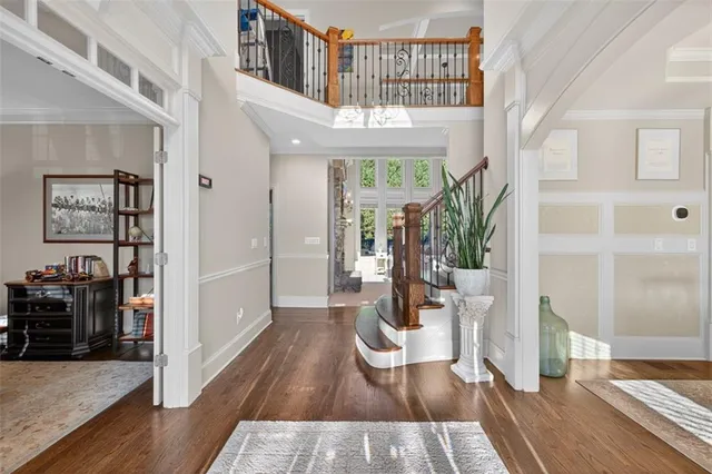 a living room with furniture fireplace and a large window