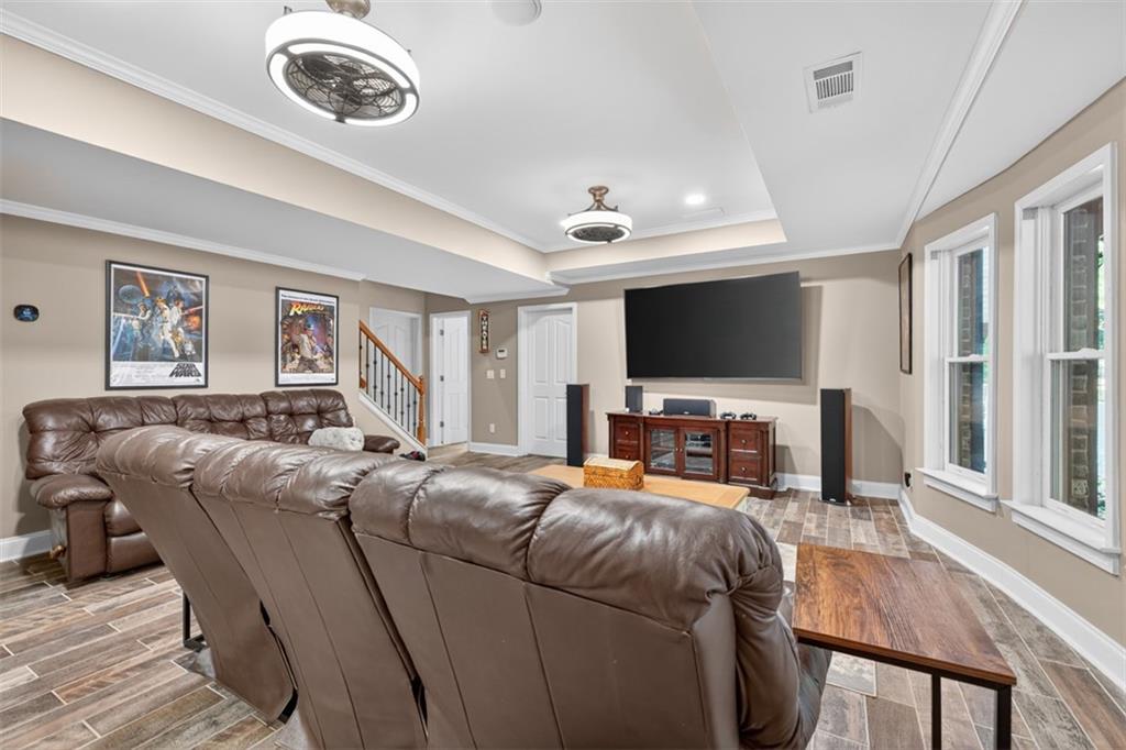909 Pathview Court Dacula, GA 30019 - Photo 72 of 113 a living room with furniture and a flat screen tv