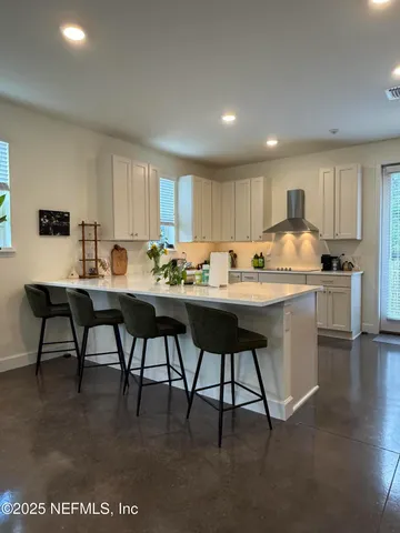 a view of a kitchen with dishwasher and white cabinets