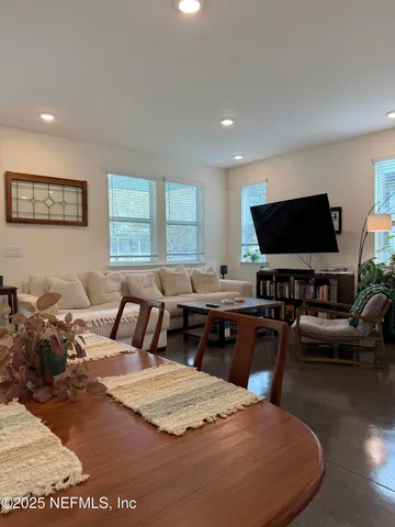 a bedroom with a bed couch and window