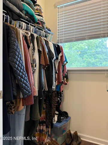 a bathroom with a sink a toilet a mirror and shower