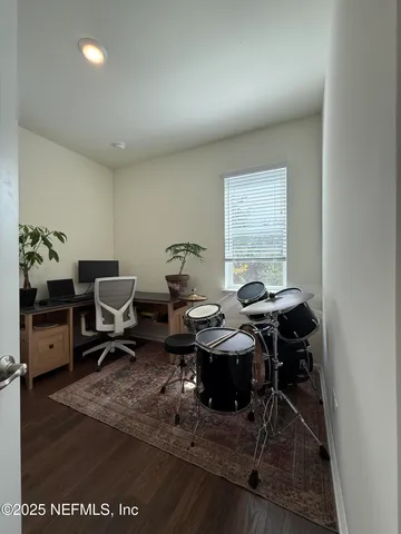 a view of a backyard with plants and large trees