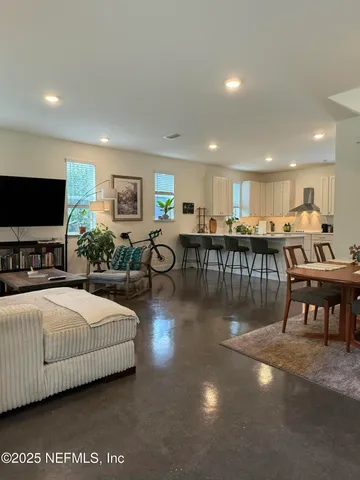 a living room with furniture window and wooden floor