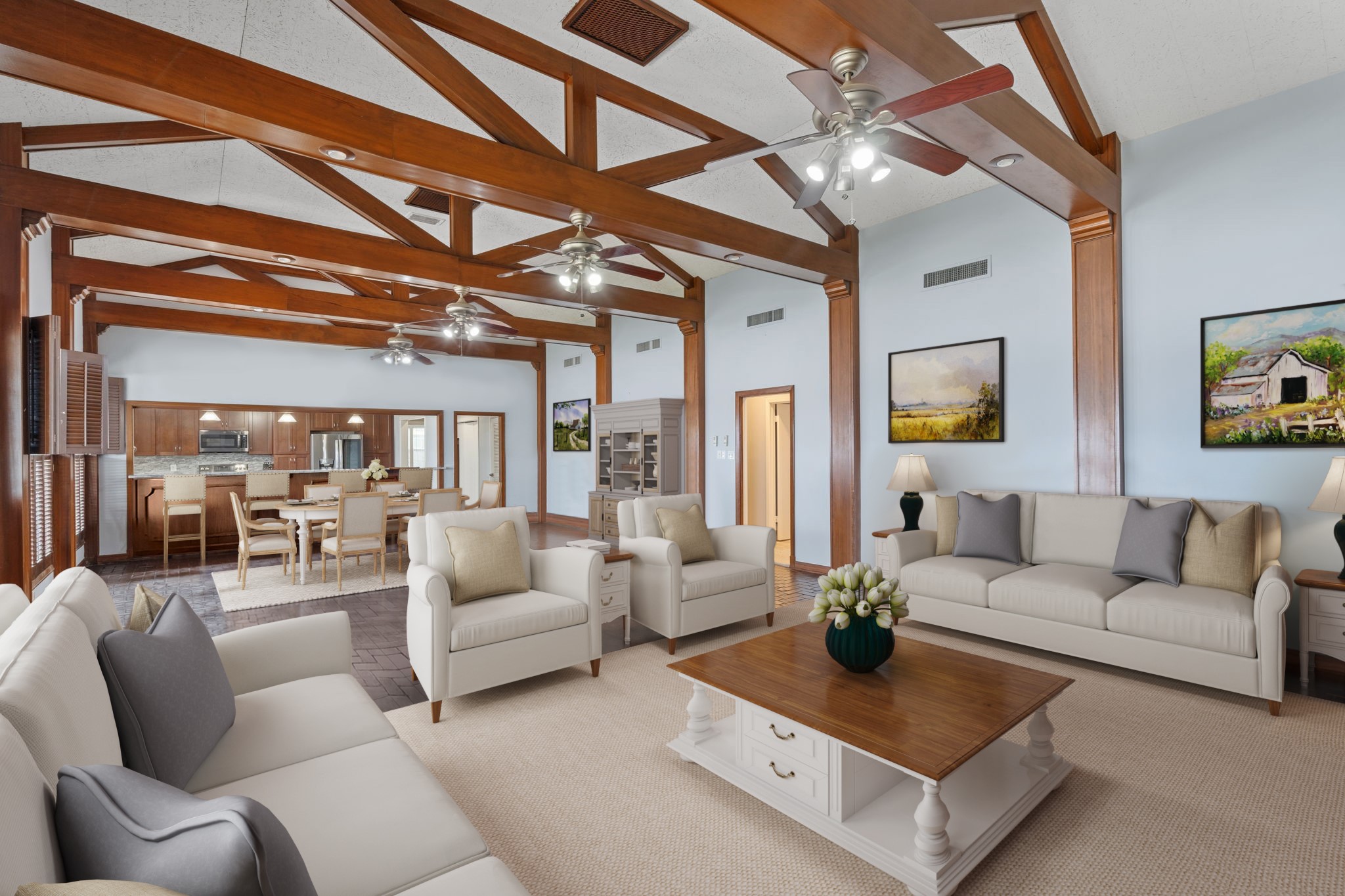 2935 West Fm 1462 Rosharon, TX 77583 - Photo 17 of 50 Virtually Staged: This expansive ranch living and dining area highlights classic ranch architecture with an open, welcoming layout designed for gathering and everyday comfort. Exposed wood beams and trusses stretch across the vaulted ceiling, adding warmth, character, and a strong sense of craftsmanship. Multiple ceiling fans and recessed lighting enhance airflow and function, ideal for relaxed ranch living.