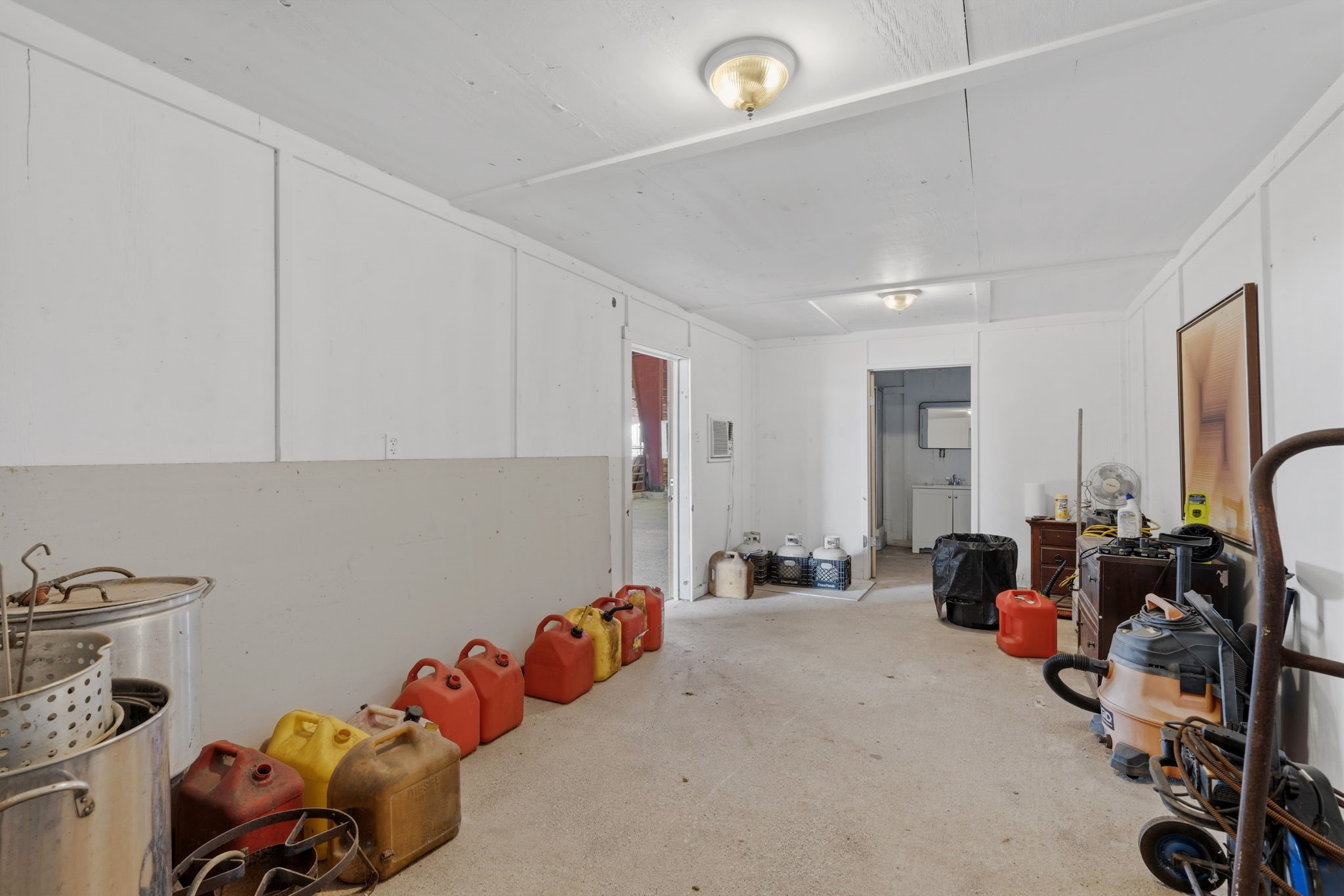 2935 West Fm 1462 Rosharon, TX 77583 - Photo 32 of 50 This large, open utility space offers exceptional flexibility to support a wide range of ranch needs. With expansive floor area, solid walls, and overhead lighting, the room provides plenty of space for storage, equipment staging, or workshop use. The open layout allows for easy organization of tools, supplies, and fuel containers, while multiple access points improve functionality and flow.