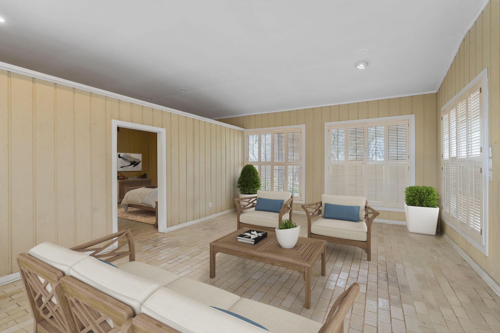 2935 West Fm 1462 Rosharon, TX 77583 - Photo 41 of 50 Virtually Staged: This relaxed pool house living area offers a comfortable gathering space designed for easy ranch-style living. Warm wood-paneled walls and durable tile flooring make it ideal for entertaining straight from the pool or after a day outdoors. Large windows with plantation shutters bring in natural light while maintaining privacy, creating a bright and breezy atmosphere.