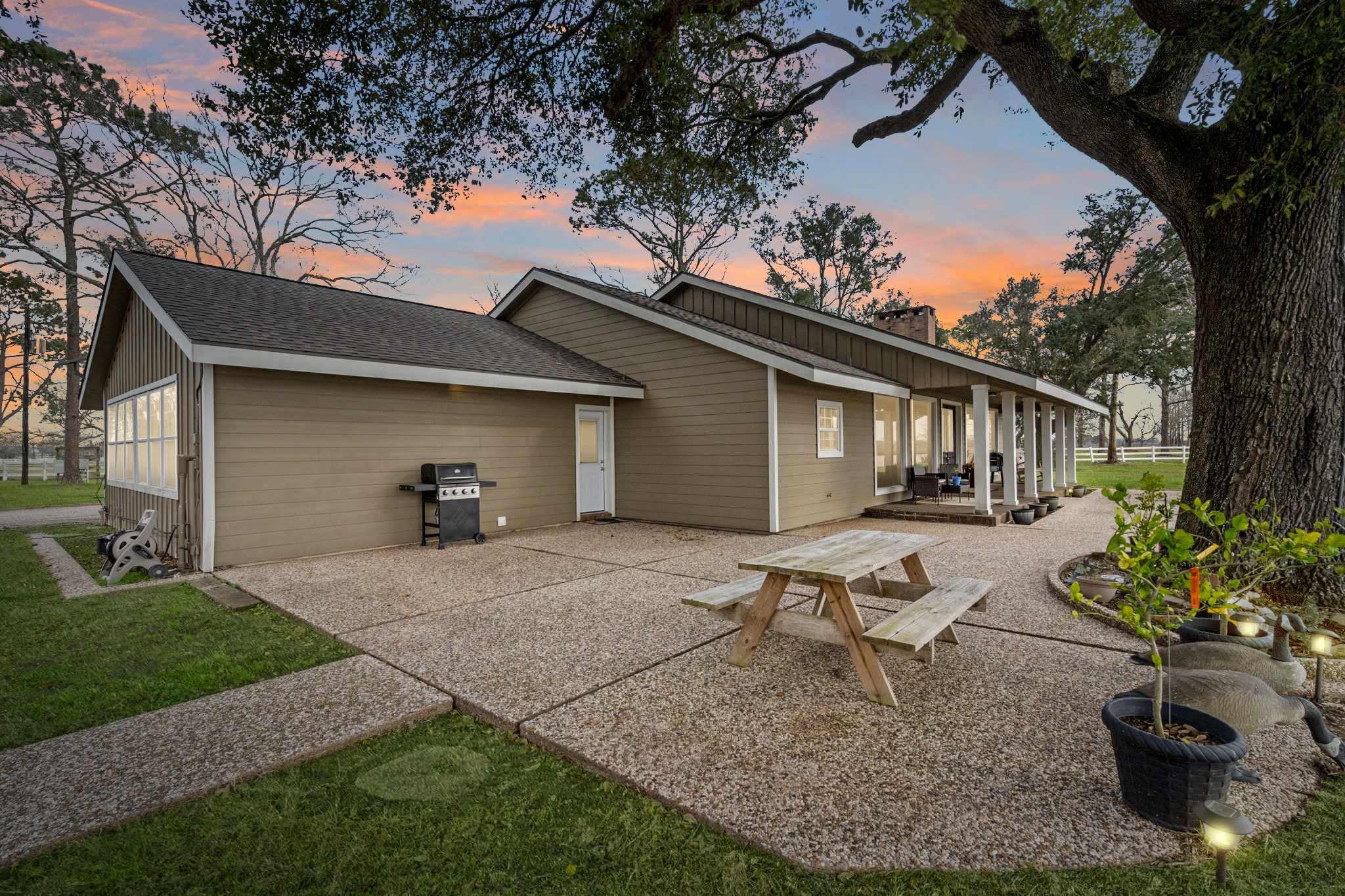 2935 West Fm 1462 Rosharon, TX 77583 - Photo 10 of 50 Set against mature trees and open skies, this exterior captures the charm, comfort, and easygoing lifestyle of true ranch living.