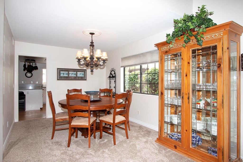 14866 Oakline Road Poway, CA 92064 - Photo 11 of 49 a dining room with furniture a chandelier and window