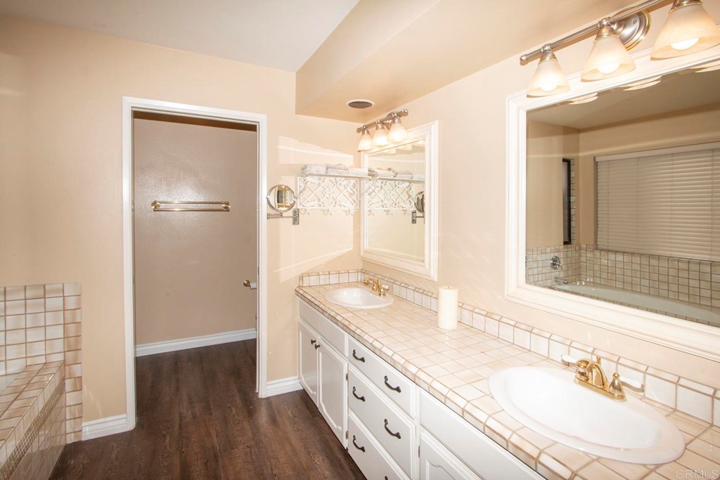 14866 Oakline Road Poway, CA 92064 - Photo 24 of 49 a bathroom with a granite countertop double vanity sink mirror and