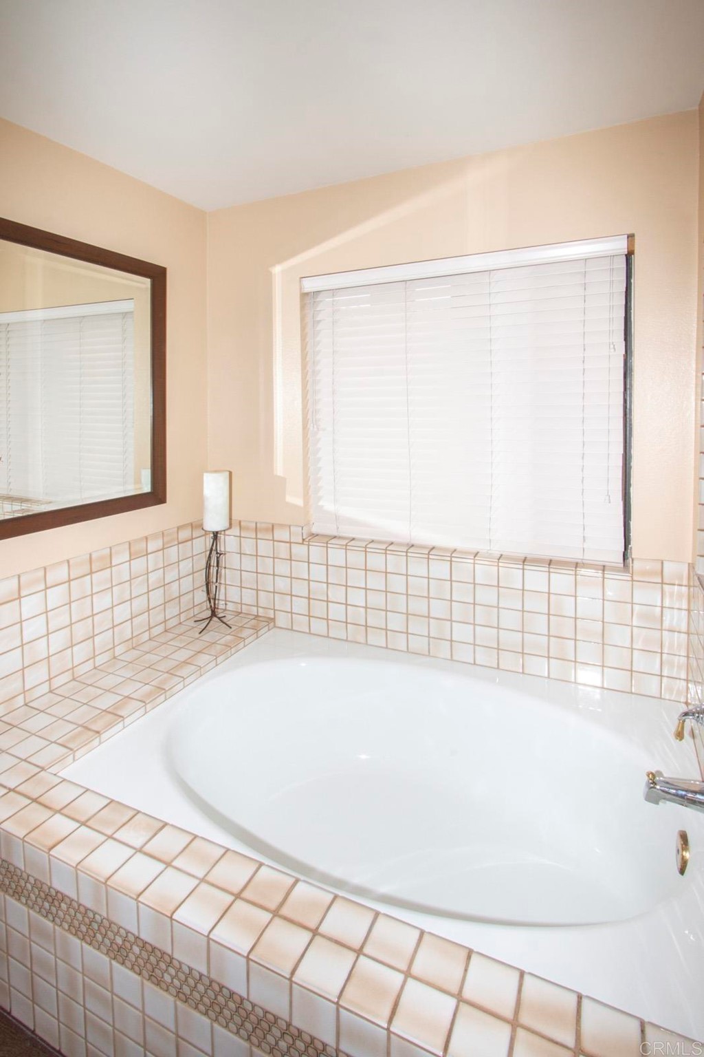 14866 Oakline Road Poway, CA 92064 - Photo 25 of 49 a white bath tub sitting in a bathroom next to a window