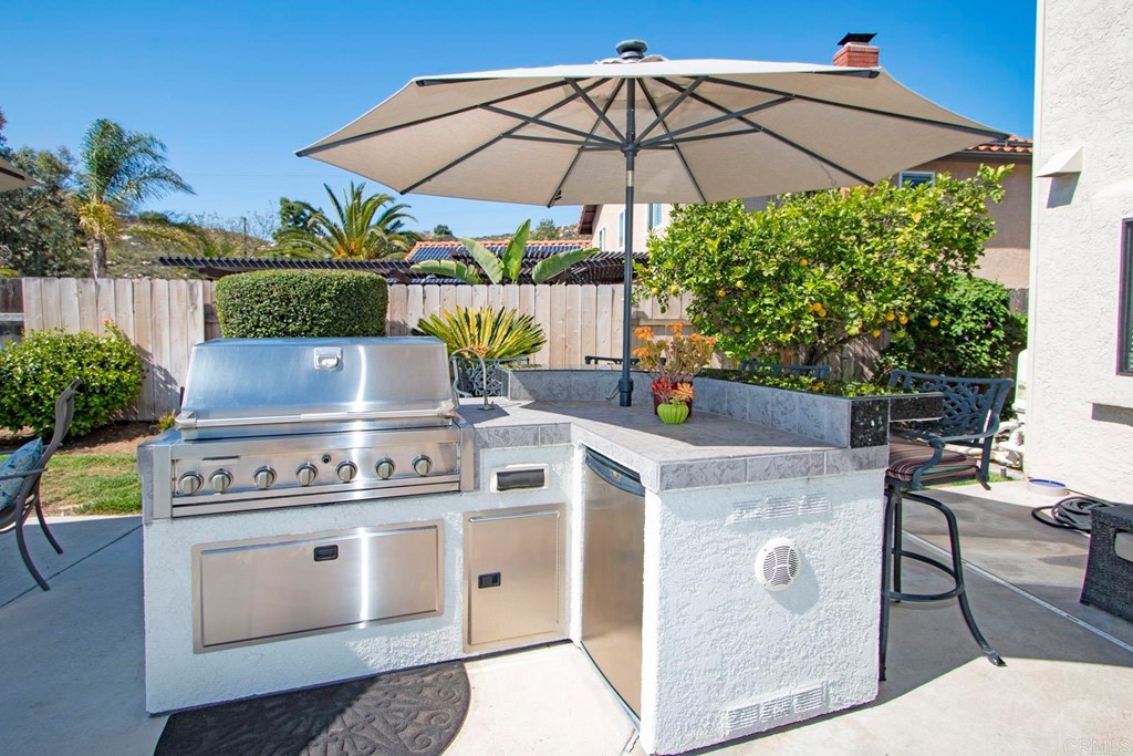 14866 Oakline Road Poway, CA 92064 - Photo 40 of 49 a view of a backyard with plants and a table