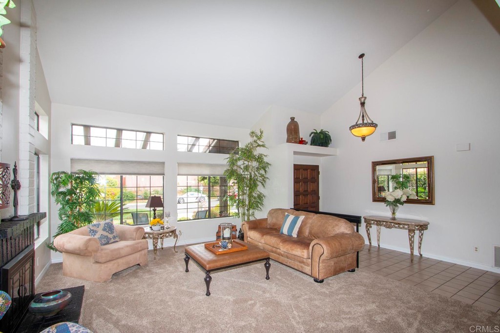14866 Oakline Road Poway, CA 92064 - Photo 7 of 49 a living room with furniture a floor to ceiling window and a flat screen tv