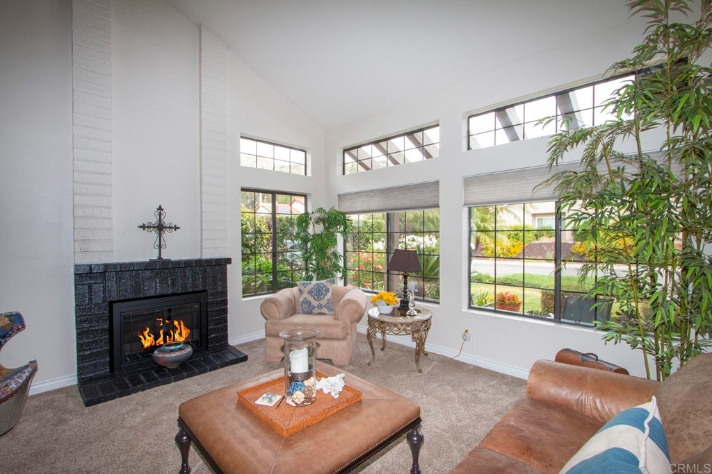 14866 Oakline Road Poway, CA 92064 - Photo 9 of 49 a living room with furniture a fireplace and a large window