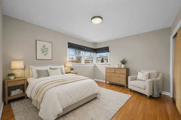 a bedroom with furniture and a wooden floor