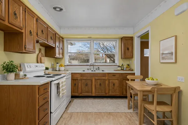 a kitchen with a sink stove and wooden cabinets