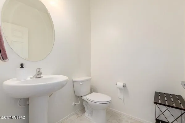 a bedroom with a bed a chandelier and a couch