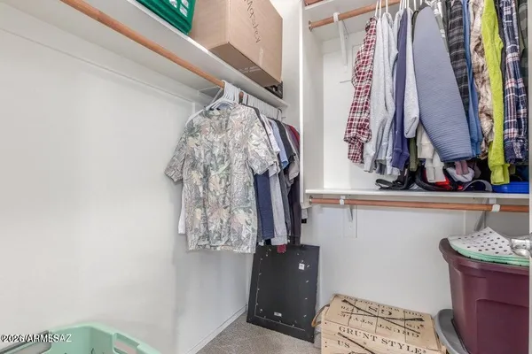 a living room with couch and book shelf