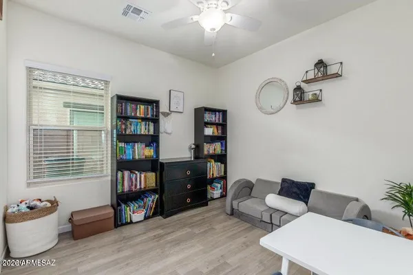 a livingroom with workspace and a window