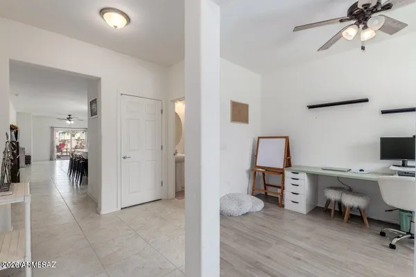 a view of a workspace with furniture and a window