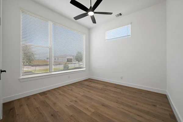 an empty room with windows and closet