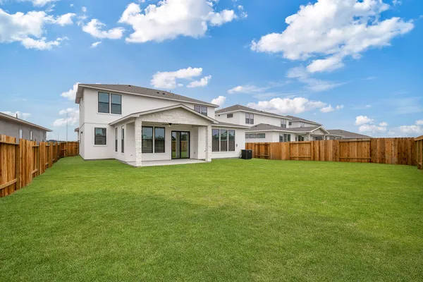 a view of a house with a backyard