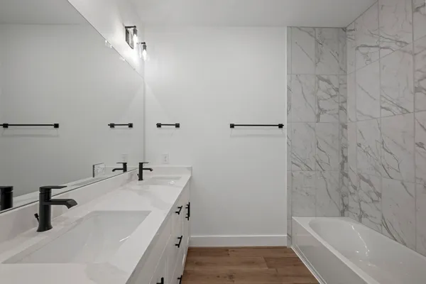 a view of bathroom with a sink mirror and shower