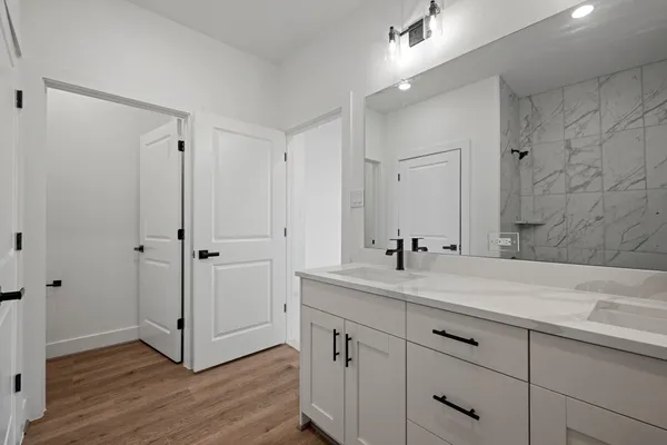 a bathroom with a double vanity sink and mirror