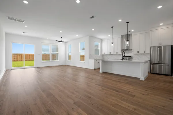 a view of kitchen with stainless steel appliances refrigerator oven and cabinets