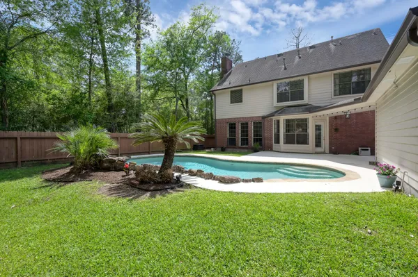 a view of a house with a yard patio and a small yard