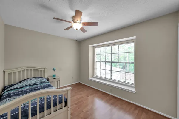 a bedroom with a large bed and a window