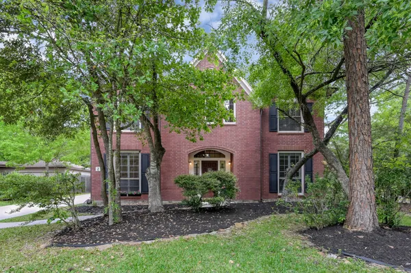 front view of a house with a tree