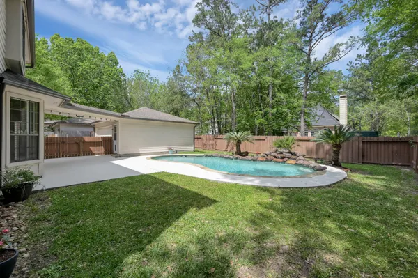 a view of a house with backyard and sitting area