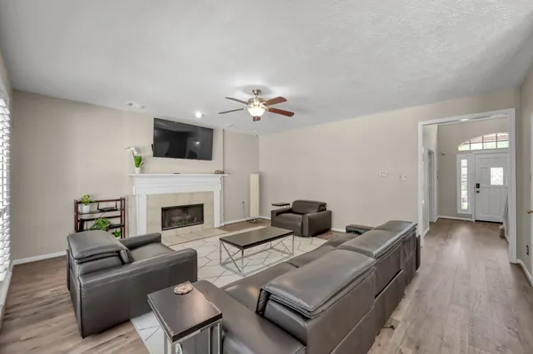 a living room with furniture a fireplace and a flat screen tv