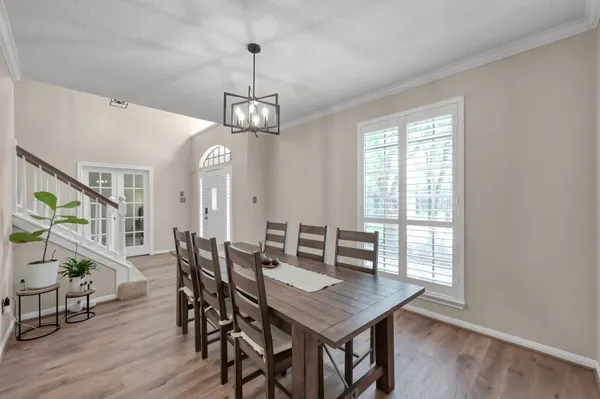a view of a dining room with furniture window and wooden floor