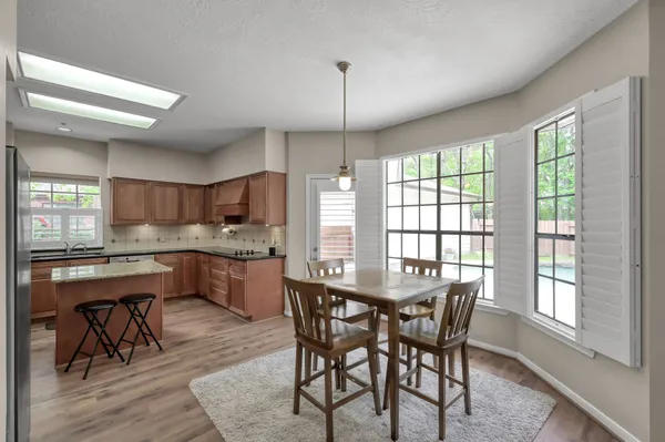 a kitchen with a table and chairs in it