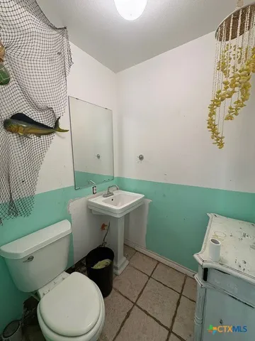 a view of a refrigerator in kitchen and a sink