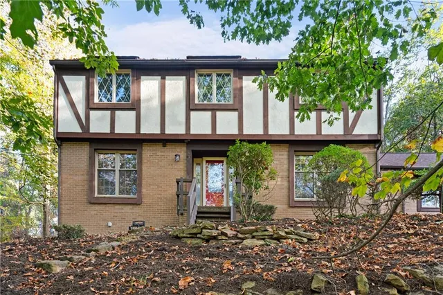 a front view of a house with garden