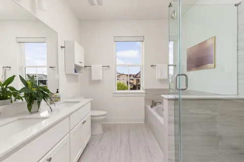 a bathroom with a double vanity sink a toilet and a mirror
