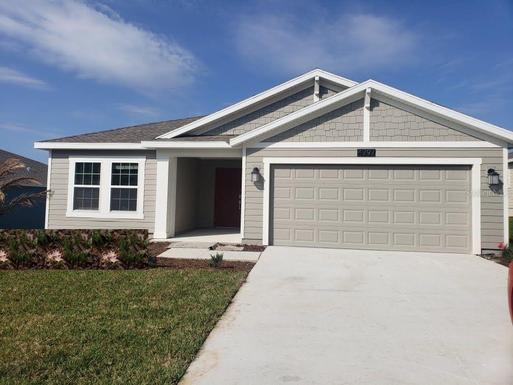 4797 Magnetite Loop Mount Mount Dora, FL 32757 - Photo 1 of 1 a front view of a house with a yard