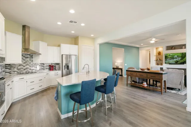 a kitchen with kitchen island wooden cabinets and stainless steel appliances