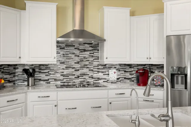 a large kitchen with lots of counter space and furniture