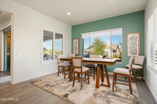 a view of a dining room with furniture and a window