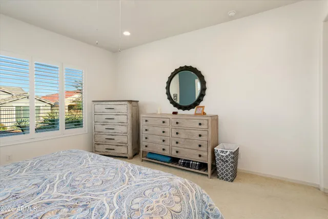 a bedroom with a bed next to a large window