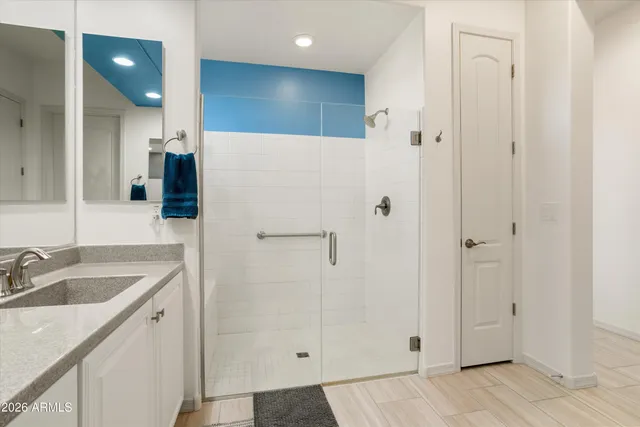 a bathroom with double sink and a mirror