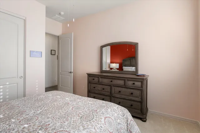 a bedroom with a bed and a dresser