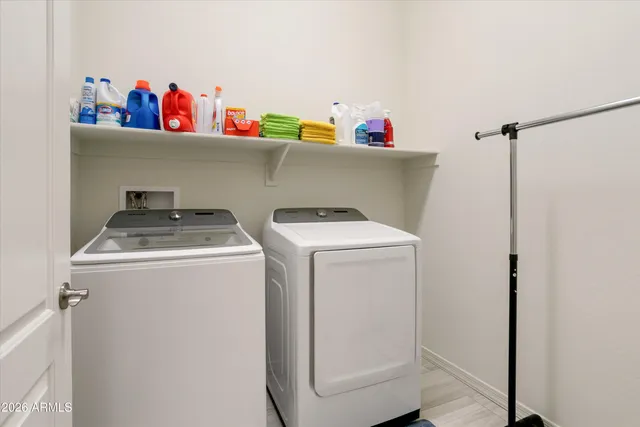 a bedroom with a bed and a lamp