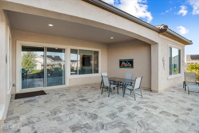 a dining room with furniture and a floor to ceiling window