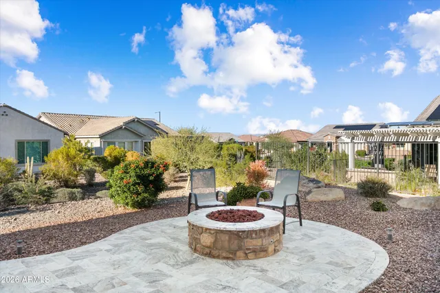 a view of a dinning table and chairs in patio of the house