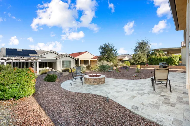 a view of a patio with a table and chairs