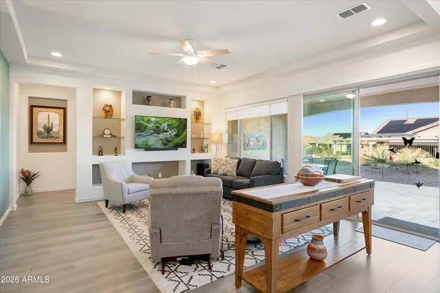 a living room with furniture and a view of kitchen